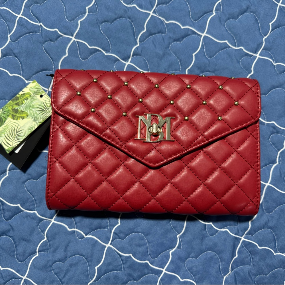Crossbody with diamond quilting and round studs on the cover. Red color , nwt